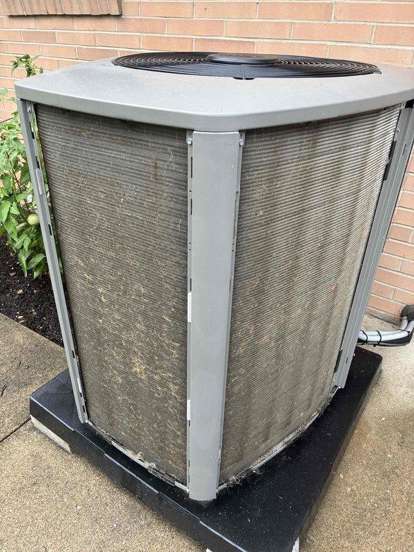 Completed preventive maintenance cooling visit on 2-year-old residential air conditioning system. Performed standard inspection of outdoor condenser unit, noting dusty coil fins consistent with normal outdoor operation. Unit found in functional condition with all components operating as designed.