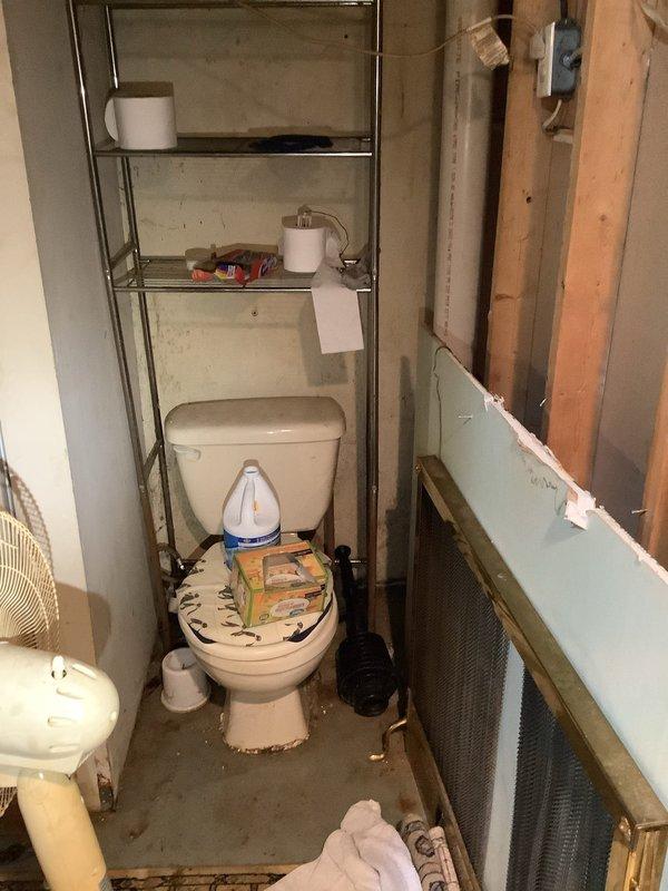 Responded to service call for water leak investigation under kitchen sink and in kitchen area. Upon arrival, conducted thorough inspection of plumbing system including crawl space access and basement drain lines. Identified compromised ceramic main drain line in basement with visible cracking and tree root intrusion. Accessed underfloor area through floor opening to assess extent of water damage and locate source of leak. Documented conditions with photographic evidence showing crawl space access point, exposed plumbing components, and affected areas. Inspected bathroom facilities revealing ongoing renovation work with exposed wall framing and removed drywall sections. Evaluated overall plumbing infrastructure to determine scope of necessary repairs. Provided second opinion assessment as requested, identifying primary issues as failed ceramic drain line requiring replacement due to structural compromise from root penetration and age-related deterioration. Recommended immediate attentio