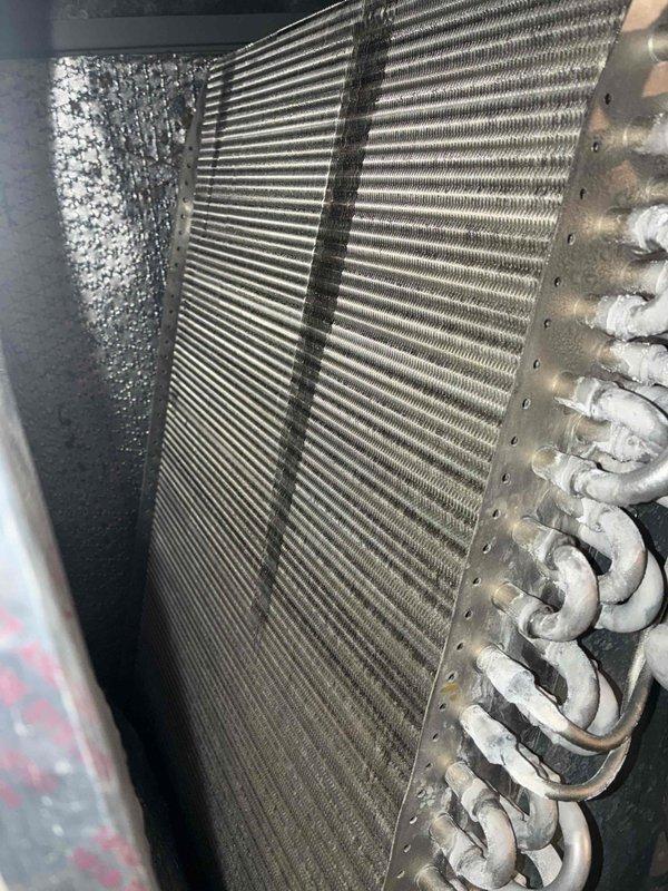 Completed routine cooling maintenance on two air conditioning systems (10-year-old and 2-year-old units). Inspected evaporator coils, noting debris accumulation on older unit's coil edges requiring attention. Verified refrigerant line connections, checked valve operations, and confirmed proper insulation on copper piping. Both systems operational and ready for continued service.