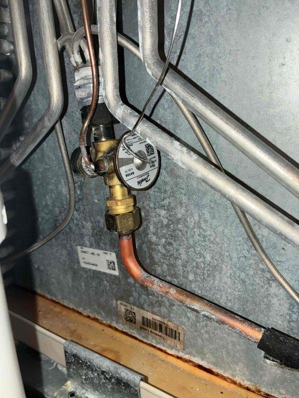Completed routine cooling maintenance on two air conditioning systems (10-year-old and 2-year-old units). Inspected evaporator coils, noting debris accumulation on older unit's coil edges requiring attention. Verified refrigerant line connections, checked valve operations, and confirmed proper insulation on copper piping. Both systems operational and ready for continued service.