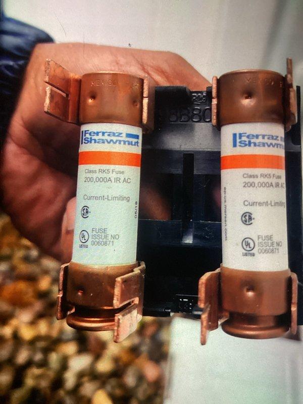 Completed scheduled cooling system maintenance visit on a 7-year-old air conditioning unit. Performed comprehensive system inspection including examination of electrical components and control board assembly. Inspected Class RK5 current-limiting fuses rated at 200,000A IR AC manufactured by Ferraz Shawmut, verifying proper fuse condition and secure mounting in fuse block. Evaluated main control board PCB and associated wiring connections, checking all wire terminations including blue, red, yellow, white, and black conductors for secure attachment and proper routing. All electrical components found in good operating condition with no signs of overheating or damage. System operational and ready for continued service.