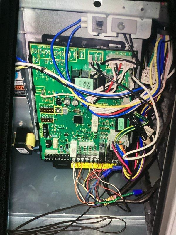 Completed scheduled cooling system maintenance visit on a 7-year-old air conditioning unit. Performed comprehensive system inspection including examination of electrical components and control board assembly. Inspected Class RK5 current-limiting fuses rated at 200,000A IR AC manufactured by Ferraz Shawmut, verifying proper fuse condition and secure mounting in fuse block. Evaluated main control board PCB and associated wiring connections, checking all wire terminations including blue, red, yellow, white, and black conductors for secure attachment and proper routing. All electrical components found in good operating condition with no signs of overheating or damage. System operational and ready for continued service.