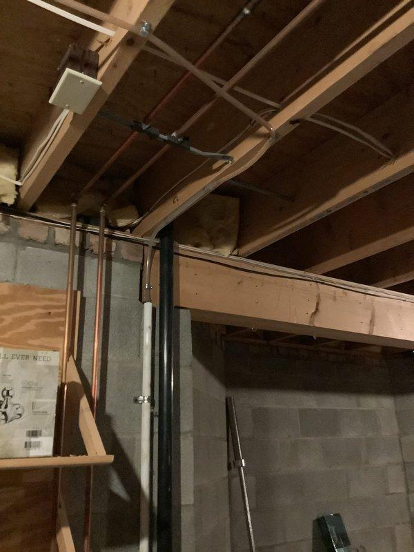 Installed new natural gas line from existing supply to exterior grill location. Ran black iron pipe through basement ceiling joists, secured with appropriate hangers and supports per code requirements. Terminated line at exterior wall with shutoff valve and weatherproof connection point for grill hookup. Pressure tested system to ensure no leaks and verified proper gas flow to appliance connection.