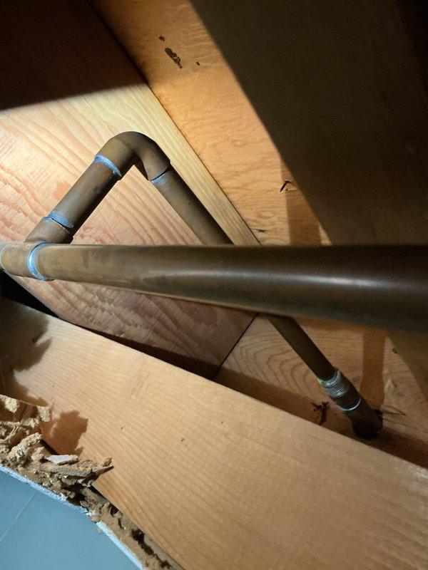 Responded to service call for leaking outdoor spigot. Upon arrival, inspected exterior hose bib mounted on brick wall and identified active leak at valve assembly. Performed pressure test using calibrated gauge to assess system integrity and pinpoint source of water loss. Traced supply lines through interior wall framing where copper piping was routed with insulated protection. Evaluated pipe insulation condition and secured loose sections with additional strapping to prevent future damage from temperature fluctuations. Repaired valve assembly and verified proper operation with blue-handled shutoff functioning correctly. Confirmed no additional leaks present at connections and restored full water flow to outdoor spigot. System tested and operating within normal parameters upon completion.