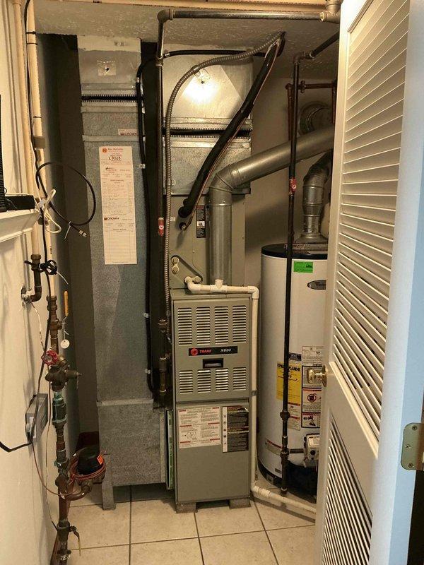 Provided estimate for complete air conditioning system replacement after diagnosing failed compressor on 21-year-old unit with no cooling capability. Documented existing outdoor condenser unit and indoor Trane XR80 furnace installation in utility closet for replacement planning and equipment sizing specifications.