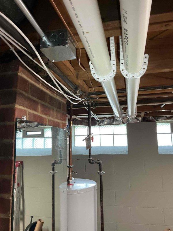 Conducted comprehensive site assessment for whole home generator installation. Evaluated existing electrical service, utility room space constraints, and mechanical system locations to determine optimal generator placement and transfer switch positioning. Documented current infrastructure including water heater, HVAC components, and plumbing systems to ensure proper clearances and code compliance for generator installation. Photographed utility areas showing available wall space, ceiling access points, and existing electrical routing to develop accurate material list and labor estimate for complete automatic standby generator system.