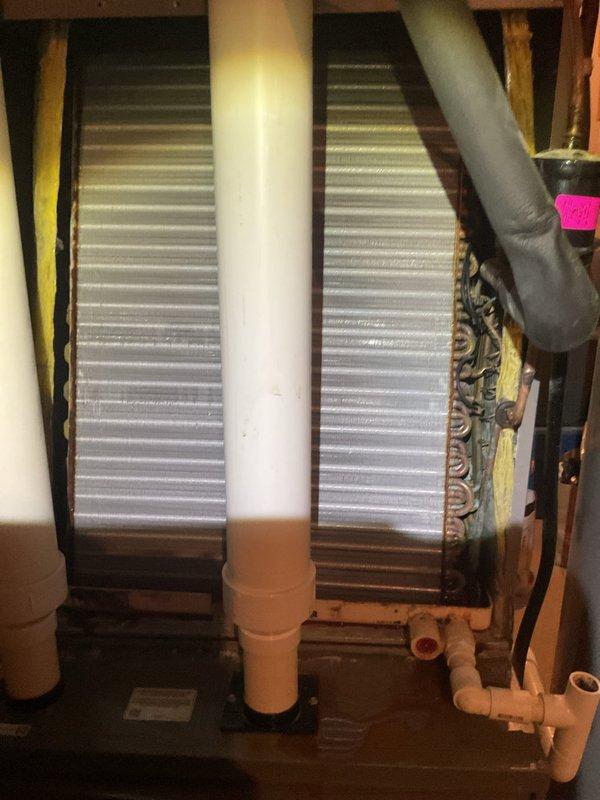 Responded to water leak complaint on 13-year-old residential AC system with water accumulating on basement floor near indoor unit. Upon inspection, identified issue with condensate drainage system at evaporator coil assembly. Cleared blockage in PVC condensate drain line, verified proper drainage flow, and confirmed unit was cooling effectively with no further water accumulation on floor.