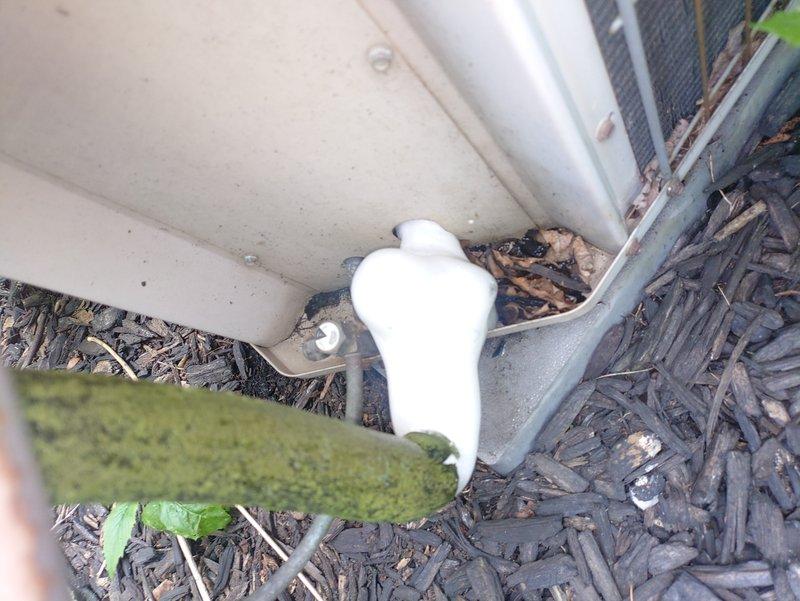 Responded to service call for 10-year-old whole-house AC system not cooling properly. Upon inspection, discovered evaporator coil completely frozen with extensive ice buildup throughout the unit, indicating restricted airflow or low refrigerant charge. Documented frost accumulation on coil assembly and surrounding components. Assessed outdoor condensing unit and associated refrigerant lines at exterior of property. System required defrost cycle completion before further diagnostic testing could be performed to determine root cause of freezing condition, which may include dirty air filter, blocked return air, low refrigerant levels, or failed blower motor.