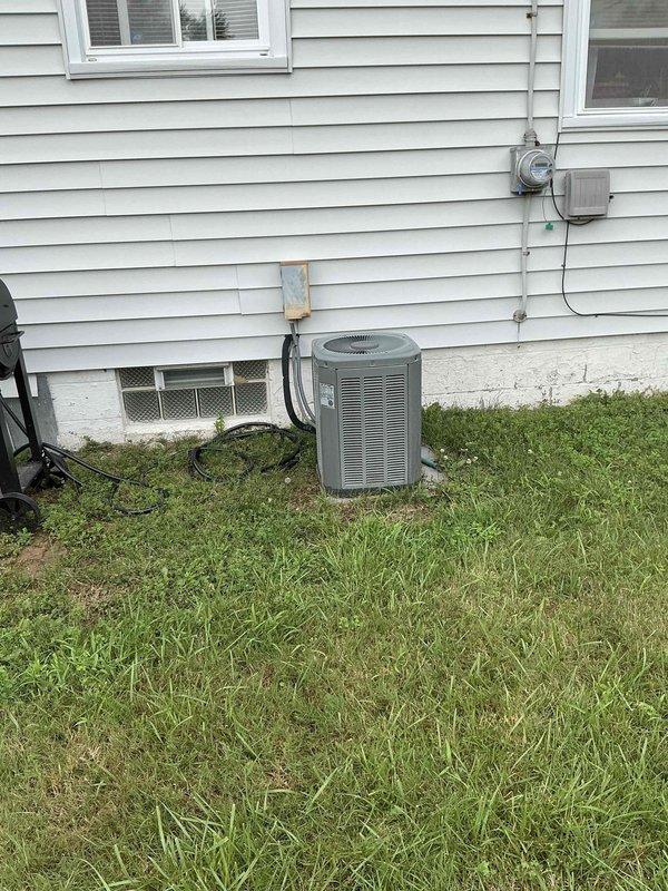 Completed estimate for replacement of 22-year-old residential HVAC system currently providing cooling. Inspected existing basement furnace installation with triangular filter access panel and associated ductwork, along with exterior condensing unit positioned on concrete pad with electrical conduit and utility connections. Documented equipment condition and provided replacement quote for aging system.