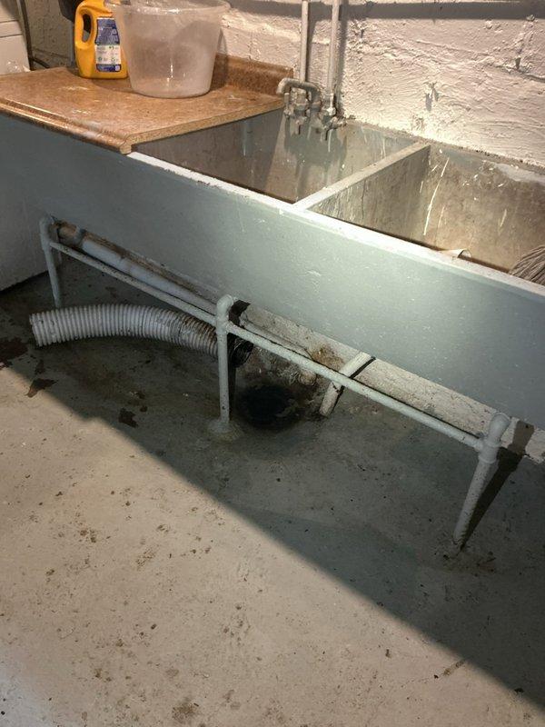 Responded to a main drain clog affecting the basement area. Upon arrival, inspected the plumbing system including the utility sink installation and main drain line with vertical PVC stack. Successfully snaked and cleared the main drain cleanout to restore proper drainage flow throughout the system, eliminating the backup issue in the basement.