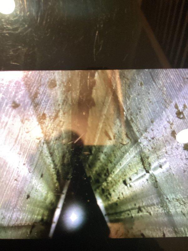Performed routine AC tune-up on an 8-year-old cooling system. During inspection, discovered significant mold growth and moisture damage inside the ductwork, with visible biological contamination on interior surfaces. Removed and cleaned return air filter, which showed heavy dirt accumulation. Documented conditions with photographs for customer review and recommended professional duct cleaning and moisture remediation to address indoor air quality concerns and prevent further microbial growth.