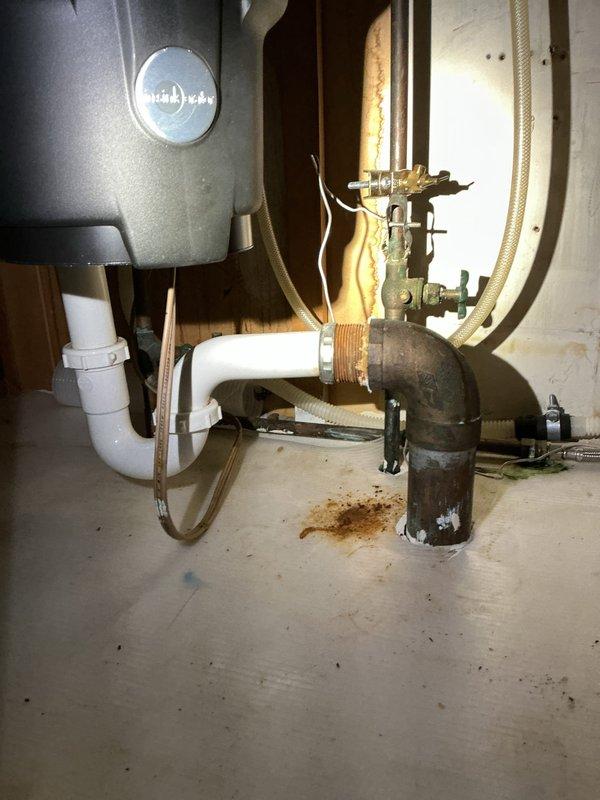 Responded to a stopped-up kitchen sink at a forty-year-old residential property where the single fixture was draining slowly or not at all. Upon inspection, confirmed the blockage was isolated to the sink drain line and not related to the dishwasher or garbage disposal connections. Accessed the drain system beneath the sink and removed the P-trap assembly to clear the obstruction, which consisted of accumulated debris and buildup typical of older plumbing systems. Cleaned the trap thoroughly, inspected the tailpiece and drain connections for proper alignment and seal integrity, then reassembled all components. Tested the drain flow with running water to verify complete clearance and proper drainage speed. Documented the condition of the existing plumbing infrastructure, noting the age-related wear on various components including corroded shut-off valves and copper supply lines that may require future attention. Restored the area to working condition and confirmed the fixture was draini