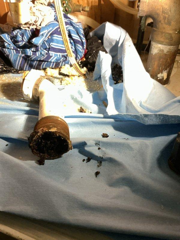 Responded to a stopped-up kitchen sink at a forty-year-old residential property where the single fixture was draining slowly or not at all. Upon inspection, confirmed the blockage was isolated to the sink drain line and not related to the dishwasher or garbage disposal connections. Accessed the drain system beneath the sink and removed the P-trap assembly to clear the obstruction, which consisted of accumulated debris and buildup typical of older plumbing systems. Cleaned the trap thoroughly, inspected the tailpiece and drain connections for proper alignment and seal integrity, then reassembled all components. Tested the drain flow with running water to verify complete clearance and proper drainage speed. Documented the condition of the existing plumbing infrastructure, noting the age-related wear on various components including corroded shut-off valves and copper supply lines that may require future attention. Restored the area to working condition and confirmed the fixture was draini