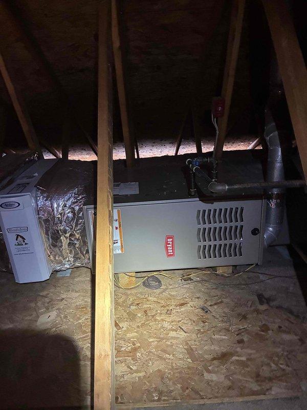 # HVAC Maintenance - Cooling Service

Performed comprehensive MVP cooling maintenance visit on residential HVAC system. Conducted thorough inspection of outdoor condenser unit, documenting significant accumulation of dirt, dust, and debris on condenser coil fins throughout the unit. The coil exhibited grayish-brown discoloration with heavy contamination buildup affecting heat transfer efficiency, though fins remained structurally intact without bending or damage. Noted organic debris and plant material at base of unit. 

Inspected indoor components in attic installation, including furnace cabinet and associated ductwork. Verified system configuration with dehumidifier integration. Documented equipment condition through photographic evidence for maintenance records. All structural components and connections found secure with no visible damage to cabinet, ductwork, or support systems.