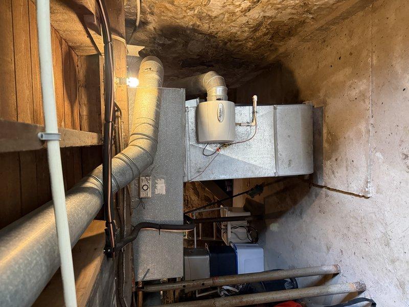 Completed second-phase air conditioning and evaporator coil installation in basement mechanical room. Installed new A/C unit with matching evaporator coil, connected flexible ductwork to existing return air system per specifications, and completed all refrigerant line sets, condensate drainage via PVC piping, and electrical connections. System tested and operating within manufacturer specifications.