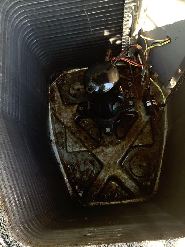 Completed MVP recurring cooling maintenance visit on 7-year-old system. Performed standard inspection of outdoor condenser unit, which showed normal operational wear with accumulated seasonal debris and leaf buildup around base. Inspected condenser coils and exterior fins, noting dirt and dust accumulation consistent with unit age. Observed significant corrosion and rust deterioration on electrical component housing and junction box, with multiple wire connections showing exposure to weather elements. Documented unit condition through photography for service records. Unit operational at time of inspection.