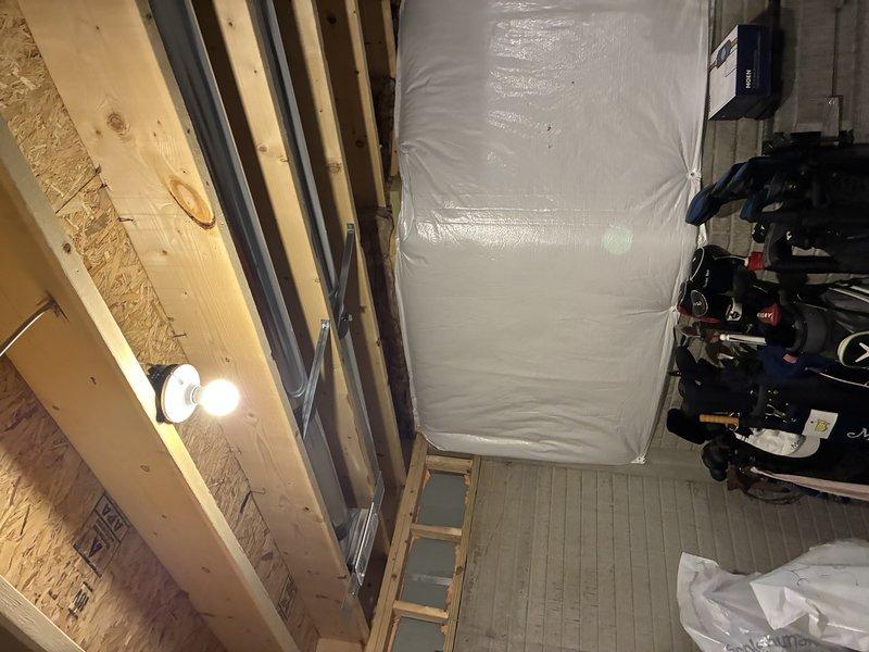 Installed electrical outlet near water meter in unfinished basement utility area to support plumbing work requirements. Outlet was wired using truck stock materials and positioned for convenient access to water meter location. Work was coordinated with related plumbing project to ensure proper sequencing of trades.