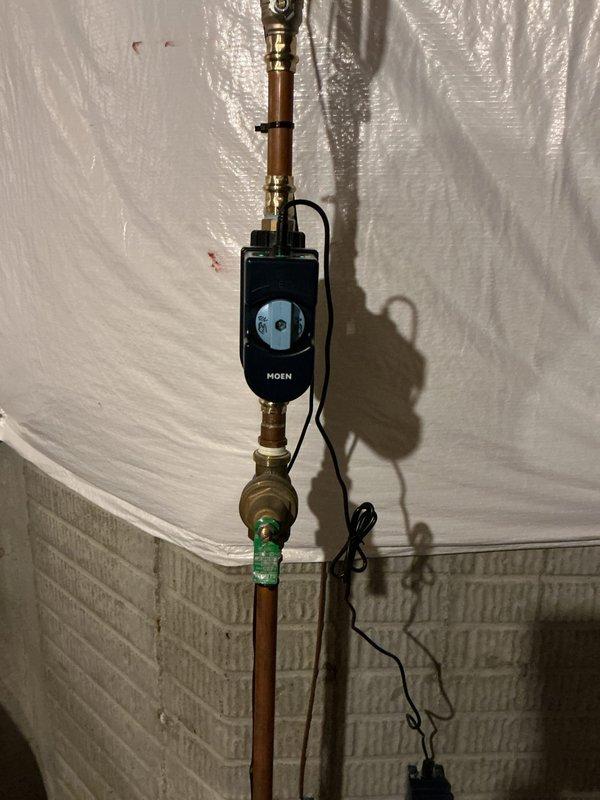 Installed whole home automatic water shut-off system with Moen smart control unit on main water line. Replaced existing shut-off valve and associated fittings with new brass connections and copper pipe sections to accommodate the electronic leak detection and automatic shut-off device. Coordinated with electrical contractor for dedicated outlet installation near water meter to power the system, ensuring proper integration of the automated water protection equipment.