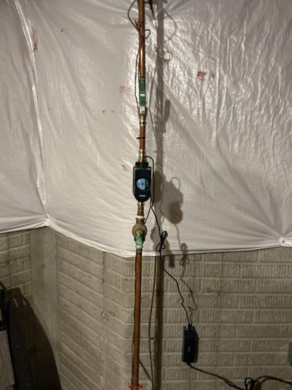 Installed whole home automatic water shut-off system with Moen smart control unit on main water line. Replaced existing shut-off valve and associated fittings with new brass connections and copper pipe sections to accommodate the electronic leak detection and automatic shut-off device. Coordinated with electrical contractor for dedicated outlet installation near water meter to power the system, ensuring proper integration of the automated water protection equipment.