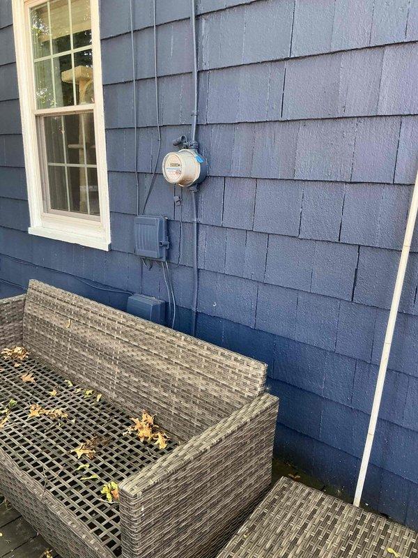 Responded to service call regarding low-hanging electrical wiring running between main residence and detached garage on property with approximately 98-year-old home. Conducted thorough assessment to determine wire function and operational status. Inspected exterior meter base, service entrance conductors, and associated junction boxes on house exterior. Traced wiring pathway from main electrical panel located in basement utility area through exterior wall penetration to garage structure. Verified circuit integrity by testing for voltage presence at multiple points along wire run. Examined main service panel and identified corresponding breaker positions. Determined wires were energized and actively supplying 120/240V power to garage subpanel for lighting and receptacle circuits. Assessed wire sag condition and evaluated support requirements per NEC standards. Documented existing installation with photographs showing meter configuration, main panel layout, and conduit routing. Provided 