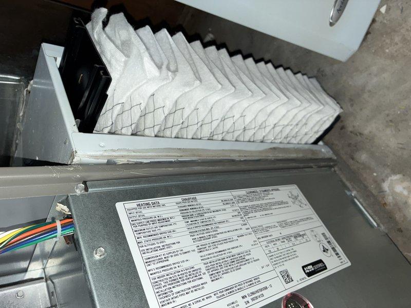 Completed routine air conditioning maintenance on a 2-year-old system for an MVP customer. Inspected furnace/air handler unit, verified clean air filter installation, examined electrical connections and capacitor within the outdoor unit, and documented all components with photos showing system in proper working condition.