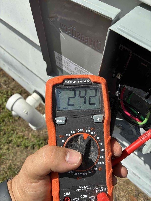 Completed AC circuit installation and panel wiring integration for HVAC system. Installed new circuit breaker in electrical panel with proper wire routing and connections, verified 242V reading at outdoor disconnect serving Frigidaire unit. All connections torqued to specification, panel dressed neatly with organized wire management, and system tested for proper operation.