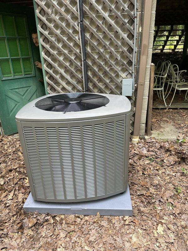 Completed installation of new air conditioning condenser unit and evaporator coil system at residential property. Unit was properly positioned on concrete pad, all electrical connections including fuse block assembly were installed and verified, and refrigerant lines were connected and tested for proper operation.
