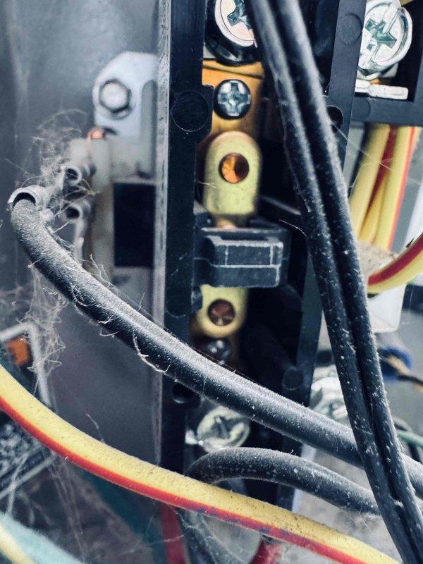 # HVAC Maintenance - Cooling

Completed routine preventive maintenance cooling visit on a 3-year-old system. Performed comprehensive inspection of all internal components including compressor, evaporator coil, blower assembly, and electrical connections. Observed significant accumulation of dust, lint, and fibrous debris throughout the electrical terminal block and wire connections, which can impede heat transfer and create potential fire hazards if left unaddressed.

Cleaned electrical connections and terminal strips, removing accumulated debris from wire insulation and connection points. Inspected all wire harnesses, connectors, and color-coded conductors for proper routing and secure attachment. Verified integrity of black rubber hoses, metal fittings, and mechanical connections throughout the unit. Checked pressure gauge readings and confirmed all components operating within normal parameters.

Examined internal assembly including motor, pump components, and QR-coded control module