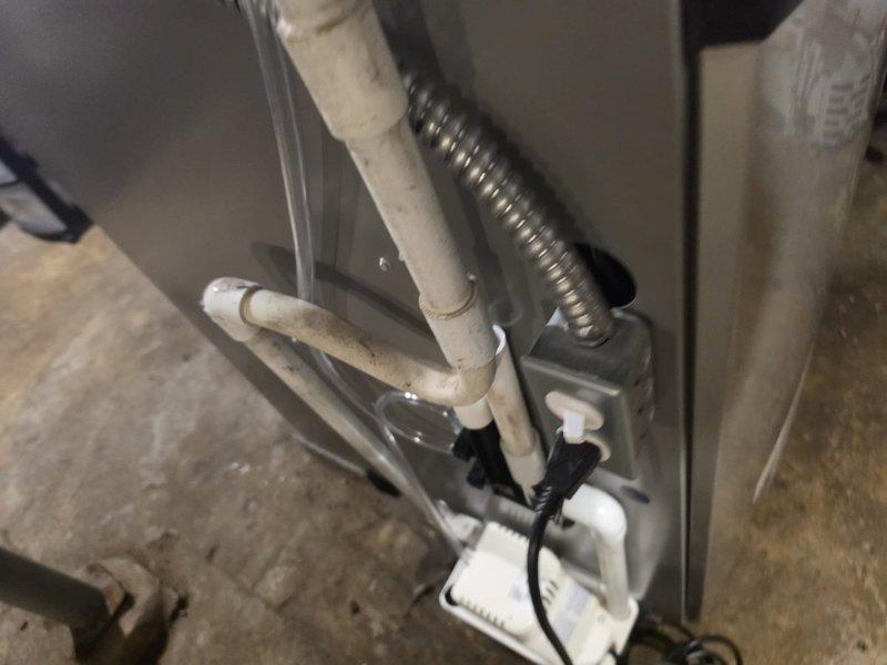 Completed installation of 90% efficiency furnace as first-stage job. Installed PVC condensate drain lines, gas piping with shut-off valve, and flexible electrical conduit connections. Unit positioned in basement mechanical space with proper venting and drainage systems in place.