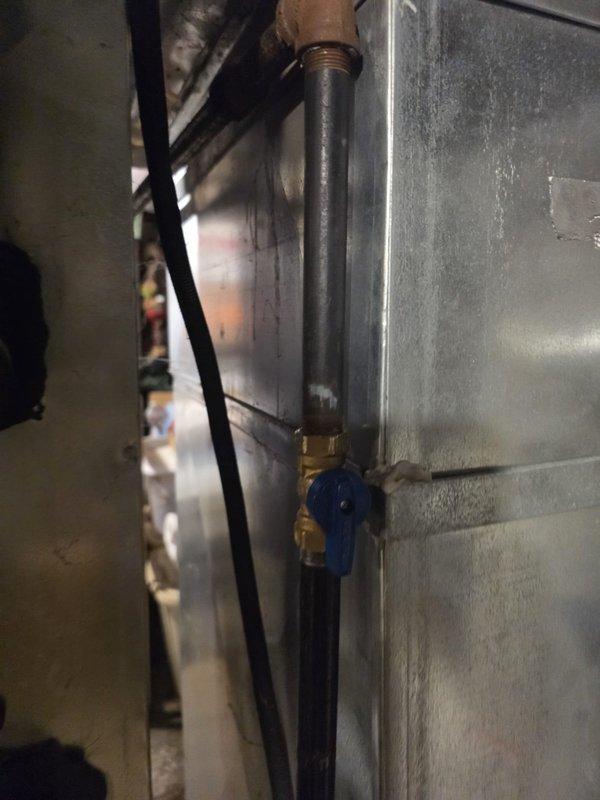 Completed installation of 90% efficiency furnace as first-stage job. Installed PVC condensate drain lines, gas piping with shut-off valve, and flexible electrical conduit connections. Unit positioned in basement mechanical space with proper venting and drainage systems in place.