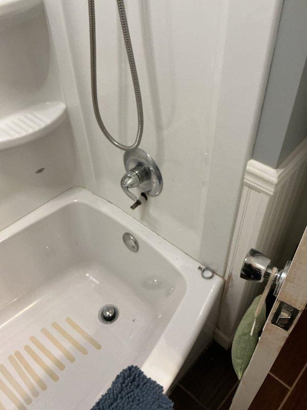 Replaced corroded bathtub spout assembly in 55-year-old residential bathroom. Removed existing chrome spout with rusted pipe connection and installed new fixture with proper wall mounting and sealing to prevent future water intrusion and corrosion.