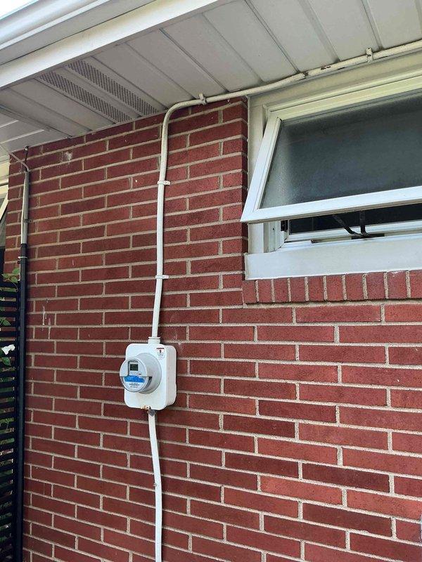 Conducted on-site assessment for generator installation and electrical panel upgrade. Evaluated existing electrical service configuration, including main panel location, meter base, and available conduit pathways along exterior brick wall. Documented current electrical infrastructure and utility connections to determine requirements for generator transfer switch installation and panel capacity upgrade. Photographed existing meter installation, service entrance conduit routing, and potential mounting locations for new equipment to develop comprehensive upgrade proposal.