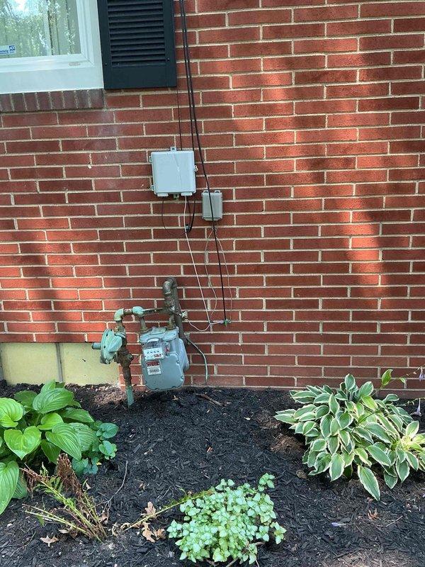 Conducted on-site assessment for generator installation and electrical panel upgrade. Evaluated existing electrical service configuration, including main panel location, meter base, and available conduit pathways along exterior brick wall. Documented current electrical infrastructure and utility connections to determine requirements for generator transfer switch installation and panel capacity upgrade. Photographed existing meter installation, service entrance conduit routing, and potential mounting locations for new equipment to develop comprehensive upgrade proposal.