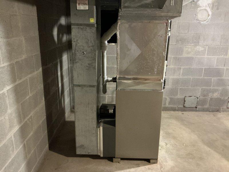 Completed on-site evaluation of 15-year-old residential air conditioning system that was not operational. Assessed outdoor condensing unit showing significant weathering and age-related deterioration, along with indoor furnace and air handler system in basement mechanical room. Provided comprehensive replacement estimate for complete HVAC system upgrade to restore cooling capacity to the residence.