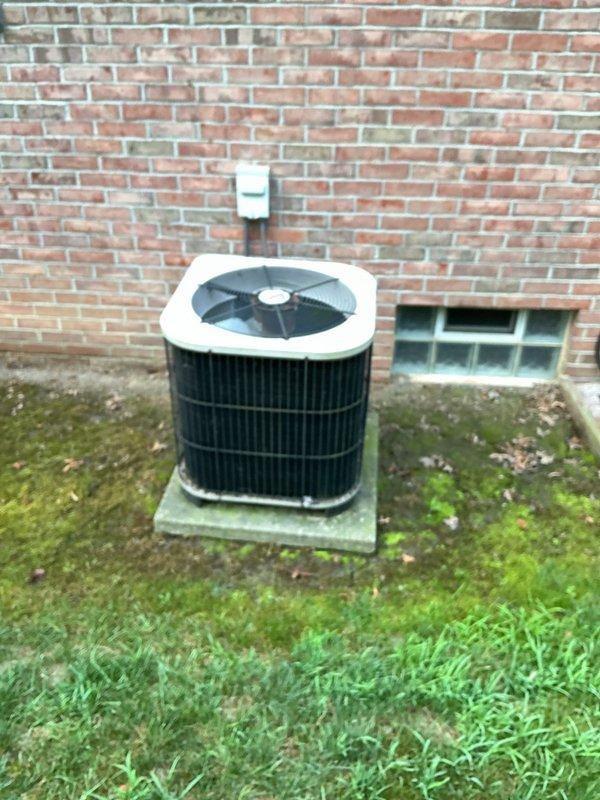 # HVAC System Installation

Completed full HVAC system installation including 80% efficiency furnace and air conditioning condensing unit. Installed new beige furnace unit in basement mechanical room with proper venting and ductwork connections. Mounted outdoor AC condensing unit on concrete pad against exterior brick wall with appropriate refrigerant line routing and electrical conduit. Verified all electrical connections, tested system operation, and confirmed proper airflow and cooling performance. System commissioned and left in full operational condition.