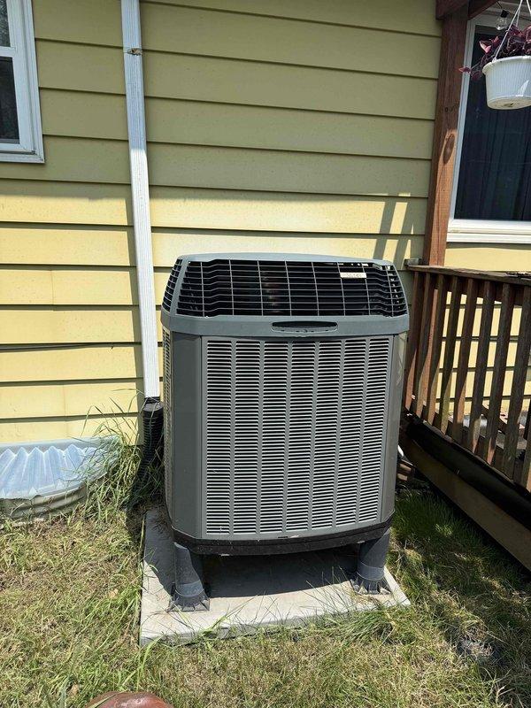 Completed MVP recurring cooling maintenance visit on residential split system. Inspected indoor electrical panel and capacitor assembly, verifying proper breaker operation and capacitor functionality marked as 16 MFD unit. Performed exterior condenser unit inspection, confirmed proper placement on pad with adequate clearance from structure, verified fan grille protection in place, and checked condensate drainage system with PVC discharge line properly secured to building exterior.