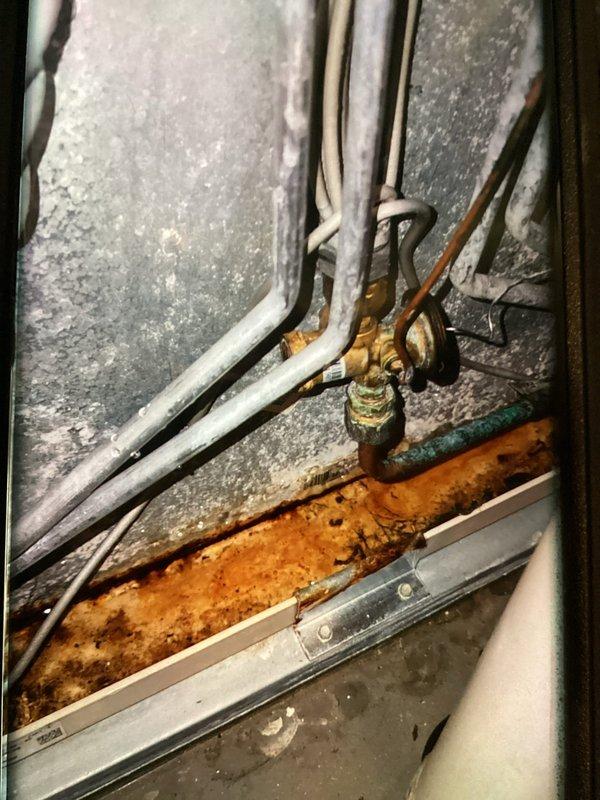 Completed MVP recurring cooling maintenance visit on residential Lennox air conditioning system. Performed standard inspection of outdoor condenser unit and indoor refrigerant line connections, documenting system condition with photos. Observed significant rust and corrosion on indoor drain pan requiring future attention, while outdoor unit and refrigerant lines appeared in serviceable condition with proper insulation intact.