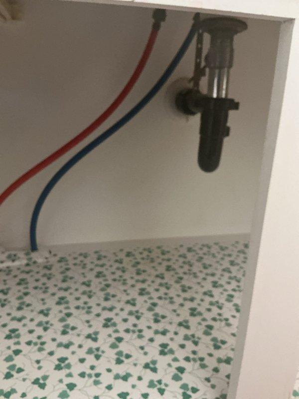 Completed full bathroom sink replacement including installation of new drop-in oval basin with chrome single-handle faucet, new pop-up drain assembly, and new shutoff valves for both hot and cold water supply lines. All plumbing connections were secured, tested for proper operation and leaks, with flexible supply lines properly connected to shutoffs and P-trap drain configuration confirmed functional.