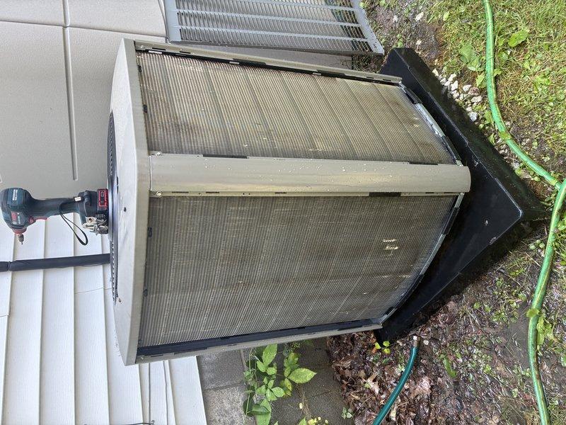Completed MVP cooling maintenance visit on outdoor heat pump unit. Disassembled unit casing to access internal components, inspected condenser coils, and found significant dirt and debris accumulation on filter panels requiring cleaning. Inspected and tested fuse block assembly containing TR32R 250VAC fuses, which showed signs of oxidation on metal terminals. Documented equipment condition with photographs for service records.