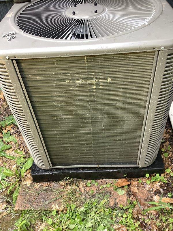 Responded to service call for furnace displaying 4 red blinks followed by 2 blinks error code and condensation issues on AC unit and ductwork. Upon inspection, found outdoor condenser unit with heavily soiled coil fins showing significant dirt, pollen, and environmental debris accumulation with greenish discoloration. Air filter on unit exhibited extreme clogging with brownish-gray particulate matter throughout pleated sections, severely restricting airflow. Diagnosed condensation on ductwork as result of inadequate airflow causing temperature differential and moisture accumulation. Documented equipment condition through photographs showing Trane condenser unit requiring cleaning and maintenance. Recommended immediate coil cleaning, filter replacement, and airflow restoration to resolve error codes and eliminate condensation problems affecting system performance.
