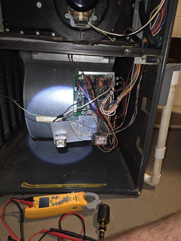 Responded to residential cooling complaint on 8-year-old air conditioning system. Upon arrival, performed diagnostic evaluation of HVAC unit using digital multimeter to test electrical components and control board functionality. Inspected furnace/air handler interior, examining green circuit board connections, blower motor assembly, and associated wiring harnesses. Verified proper voltage readings across multiple connection points including red, white, blue, brown, and yellow wire terminals. Examined blower motor operation and checked all electrical connections for secure contact and proper termination. Inspected heat exchanger assembly and verified PVC venting integrity. System tested and confirmed operational status upon completion of diagnostic procedures.