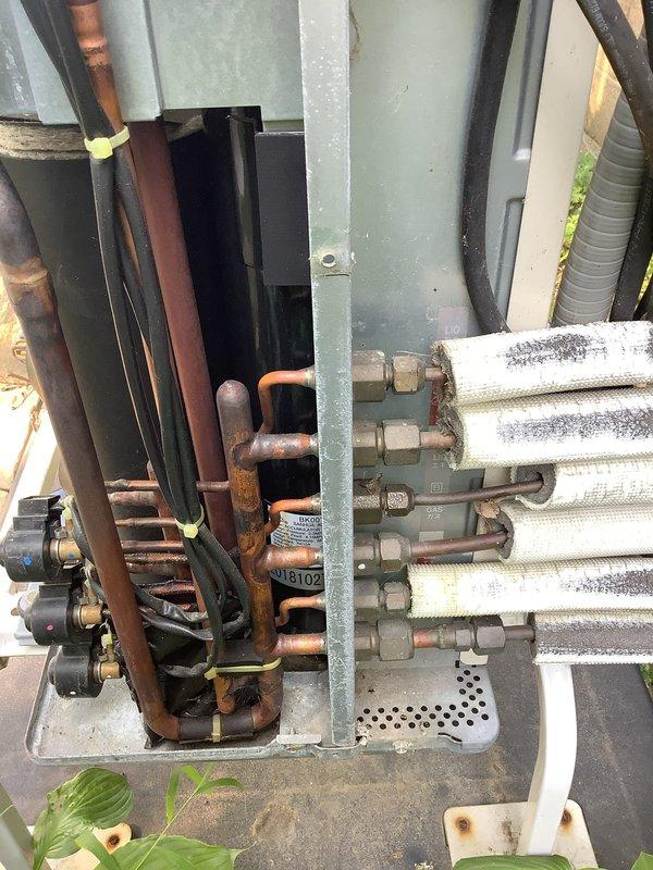 Responded to service call for three non-operational mini split systems. Upon arrival, performed diagnostic evaluation of outdoor condensing units and refrigerant line sets, which showed signs of aging with oxidized copper piping and worn insulation. Accessed internal components of exterior unit by removing side panel to inspect compressor, coils, electrical connections, and refrigerant lines. Connected manifold gauges to assess system pressures and refrigerant charge levels. Documented equipment condition through photographs showing deteriorated line set insulation, corroded fittings, and overall system wear. Customer was advised of findings and potential solutions for restoring system operation.