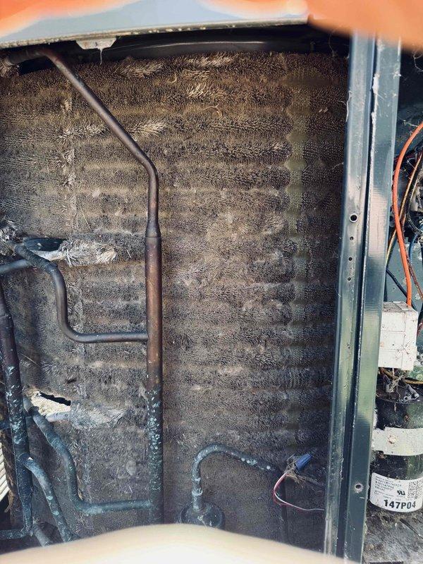 Responded to service call for non-operational air conditioning unit that had been relocated due to recent sewer line excavation work. Performed thorough inspection of outdoor condenser unit and indoor evaporator coil to verify proper reconnection and identify any issues resulting from the relocation. Found outdoor condenser unit properly positioned on concrete pad with refrigerant lines intact. However, discovered indoor evaporator coil heavily contaminated with excessive dust and debris accumulation, significantly restricting airflow and system performance. The dense buildup on coil fins indicated prolonged maintenance neglect that predated the unit relocation. Documented unit condition through photographs showing both outdoor condenser assembly and severely fouled indoor coil. Confirmed all electrical connections and refrigerant lines were properly secured following the move, with no apparent damage from relocation activities.