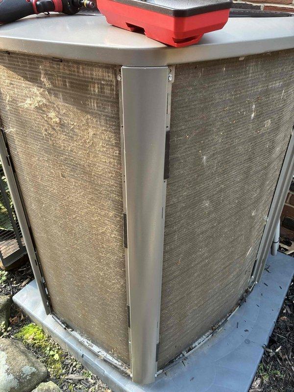 Performed scheduled cooling maintenance on residential HVAC system. Inspected outdoor condensing unit, noting accumulated dirt and debris on coil guards and mesh filter panels requiring attention. Evaluated system operation and measured suction line temperature at 51.1°F, observing normal frost accumulation on refrigerant lines indicating proper system function. Confirmed cooling system is operating within normal parameters and working properly.