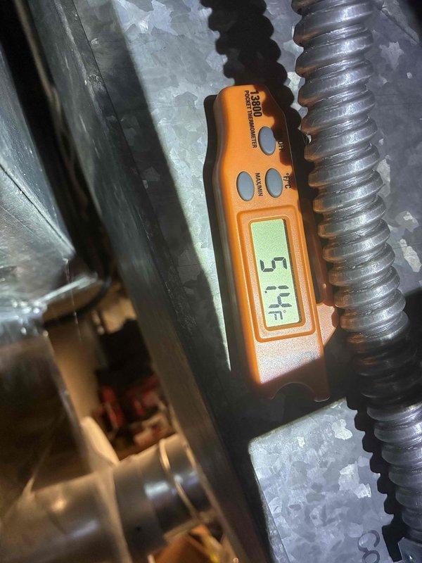 Performed scheduled cooling maintenance on residential HVAC system. Inspected outdoor condensing unit, noting accumulated dirt and debris on coil guards and mesh filter panels requiring attention. Evaluated system operation and measured suction line temperature at 51.1°F, observing normal frost accumulation on refrigerant lines indicating proper system function. Confirmed cooling system is operating within normal parameters and working properly.