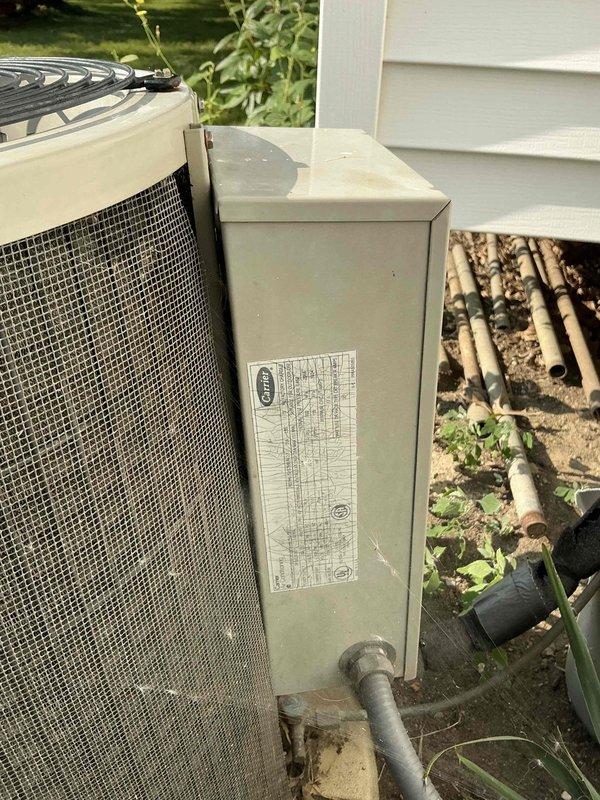 Conducted on-site assessment of aging 1990s residential air conditioning system for replacement estimate. Evaluated existing indoor furnace unit with connected ductwork in basement utility area and outdoor condenser unit with disconnect box, documented current equipment specifications and installation conditions, and photographed both components to provide comprehensive replacement proposal for obsolete HVAC system.
