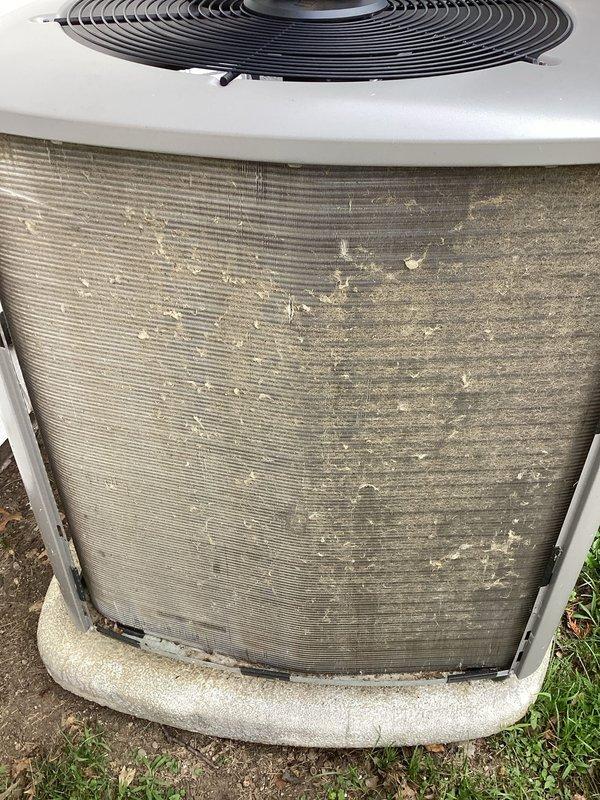 Completed MVP cooling maintenance visit on 7-year-old system. Inspected outdoor condenser unit and found heavy accumulation of dirt, dust, and debris on coil fins requiring cleaning. Documented significant brown discoloration and deterioration on PVC condensate drain piping, including crusty buildup at elbow joint and staining around pipe connections indicating potential drainage issues or mineral deposits.