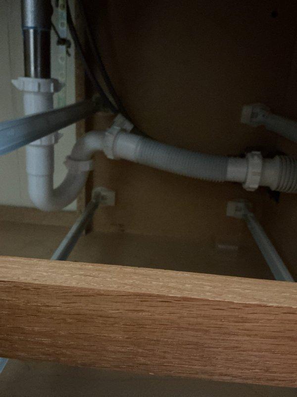 Responded to service call for garbage disposal replacement estimate and slow-draining bathroom vanity sink. Upon arrival, conducted thorough inspection of kitchen sink plumbing system and photographed existing garbage disposal unit and drain assembly configuration. Assessed current disposal mounting hardware, electrical connections, and drain line connections to determine replacement requirements and compatibility with existing plumbing infrastructure.

Examined bathroom vanity sink drain system and identified slow drainage issue. Inspected P-trap assembly, drain tailpiece, and connecting PVC pipes for potential blockages or improper venting. Documented under-sink plumbing configuration including white PVC drain components, flexible corrugated drain hose connections, and existing trap assembly. Verified electrical outlet accessibility within cabinet space for disposal installation requirements.

Provided customer with comprehensive estimate for garbage disposal replacement including re