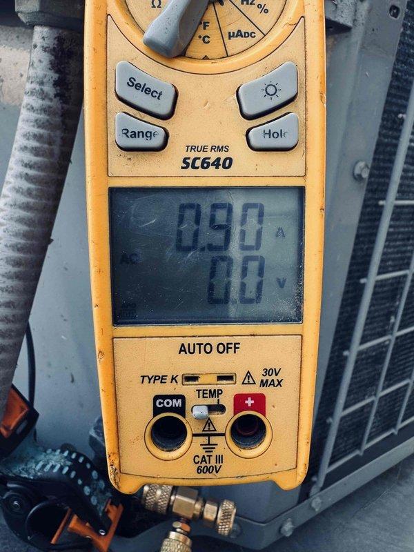Responded to no-cooling call on residential air conditioning unit reportedly damaged by hailstorm. Performed diagnostic testing using digital multimeter to measure voltage and amperage at outdoor condenser unit, checking electrical components and compressor functionality. Unit appears to be over 10 years old with visible hail damage to exterior components affecting system operation.