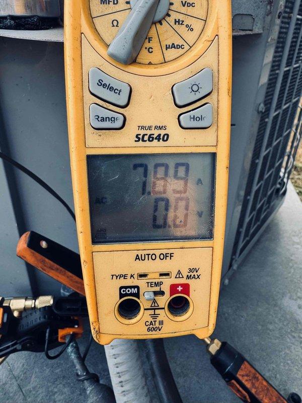 Responded to no-cooling call on residential air conditioning unit reportedly damaged by hailstorm. Performed diagnostic testing using digital multimeter to measure voltage and amperage at outdoor condenser unit, checking electrical components and compressor functionality. Unit appears to be over 10 years old with visible hail damage to exterior components affecting system operation.